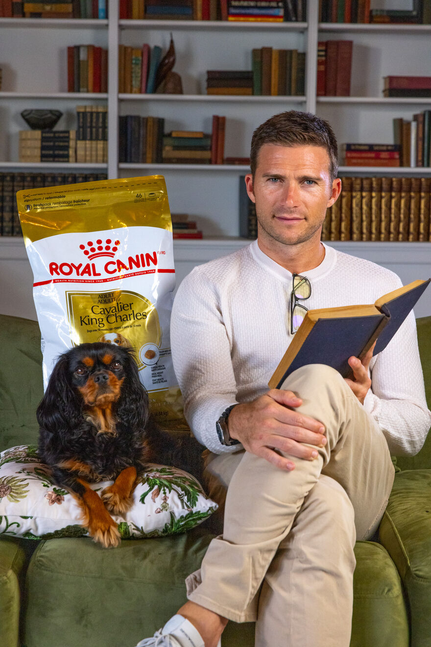 Man read a book with dog